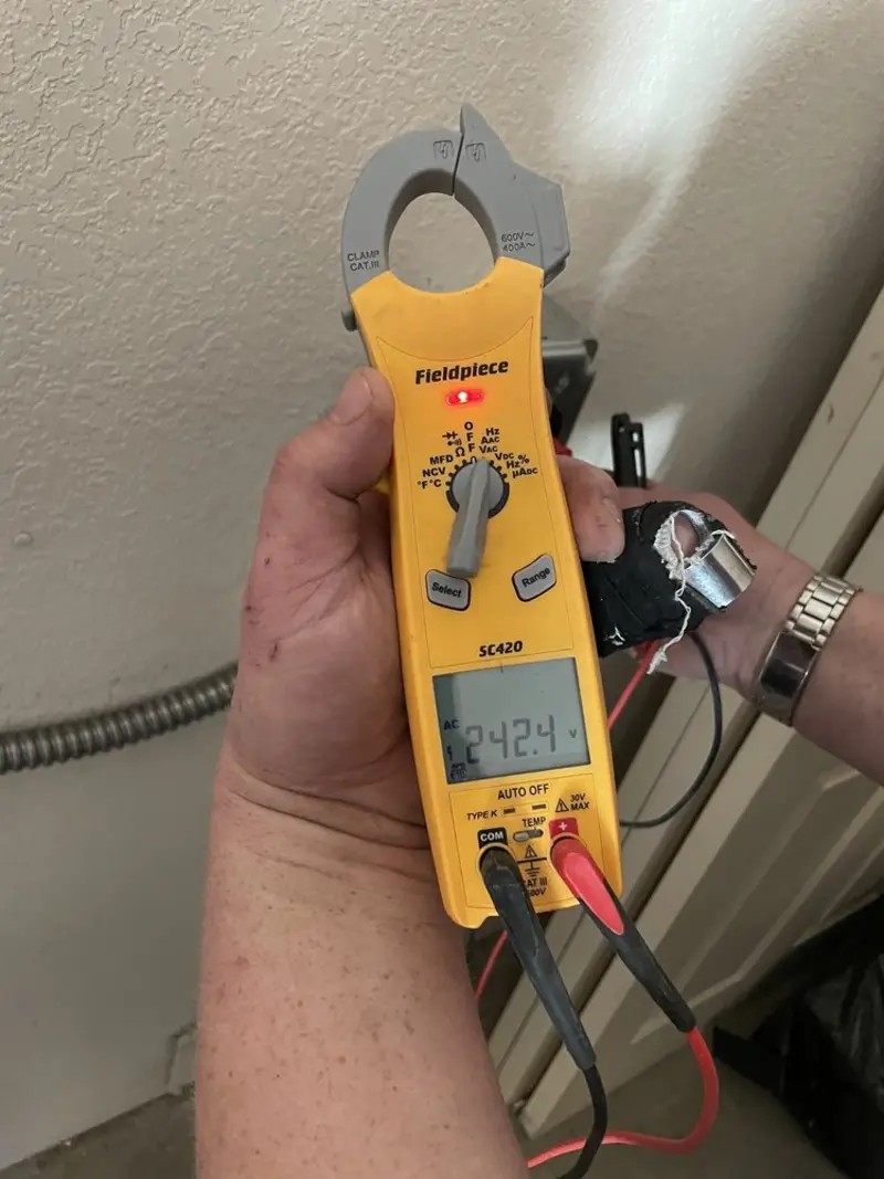 Voltage testing with clamp meter during Outlet Installation in Sherburne